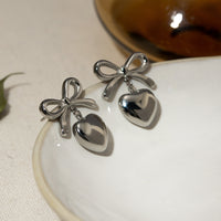 earrings, bow earrings, heart earrings, Heart jewelry, waterproof jewelry, waterproof Earrings, Heart jewelry, heart earrings, tarnish free earrings, tarnish free jewelry, kesley fashion, cheap earrings, affordable jewelry, bow earrings, dangly bow earrings, danlgy waterproof jewelry, titanium jewelry, stainless earrings, trending fashion 